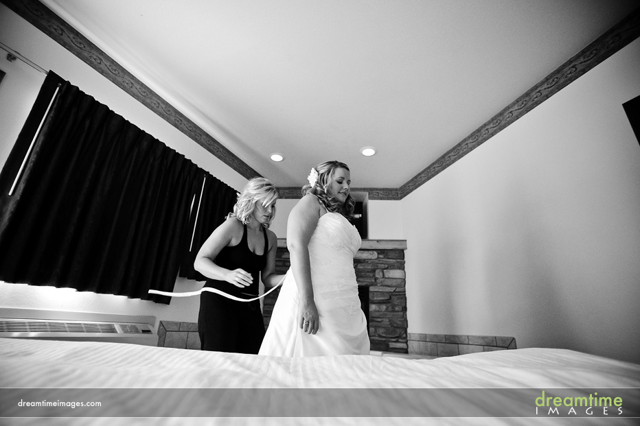 estes park wedding bride putting on dress