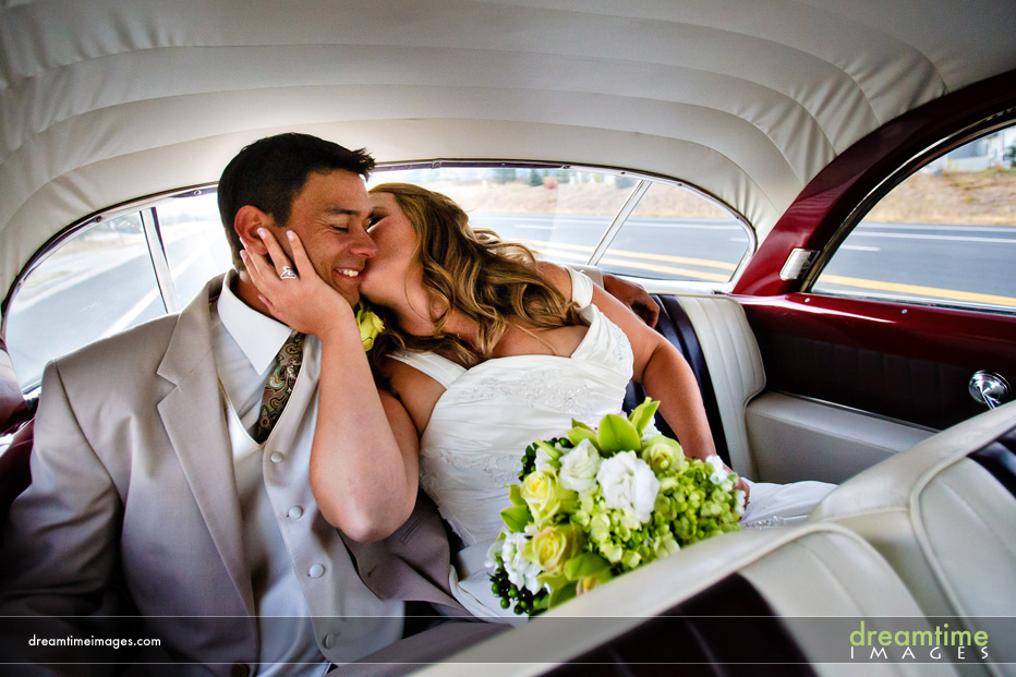 bride and groom in getaway car