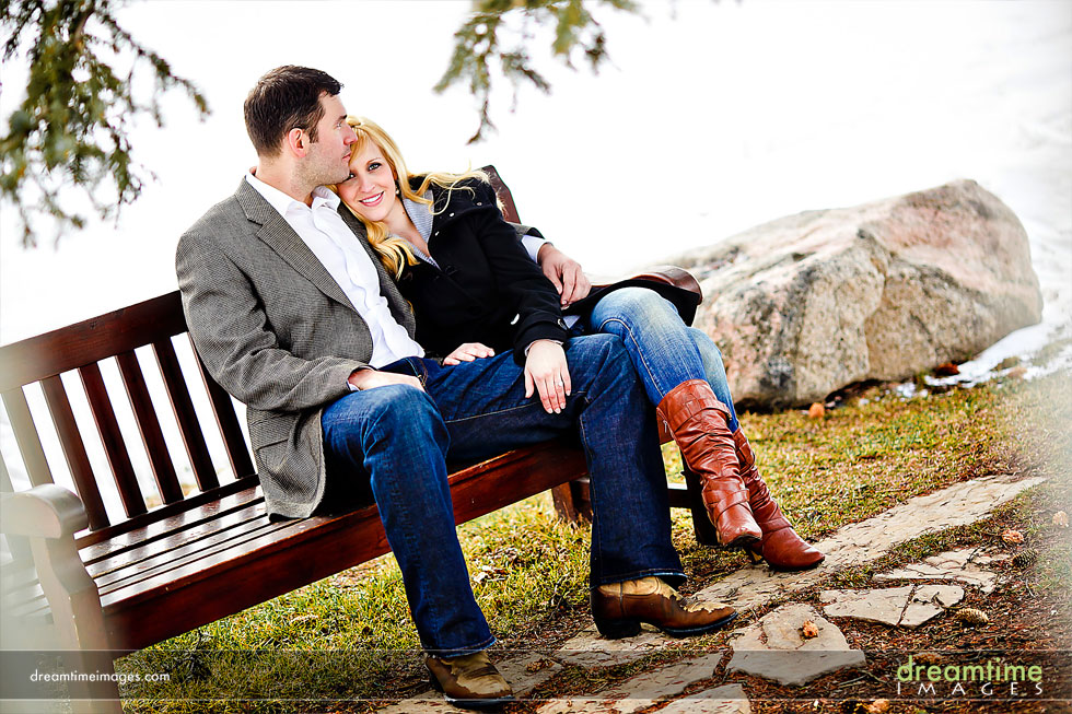 engaged couple on bench colorado