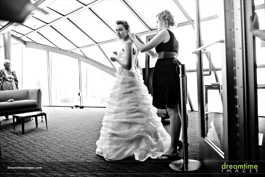 bride putting on dress in denver