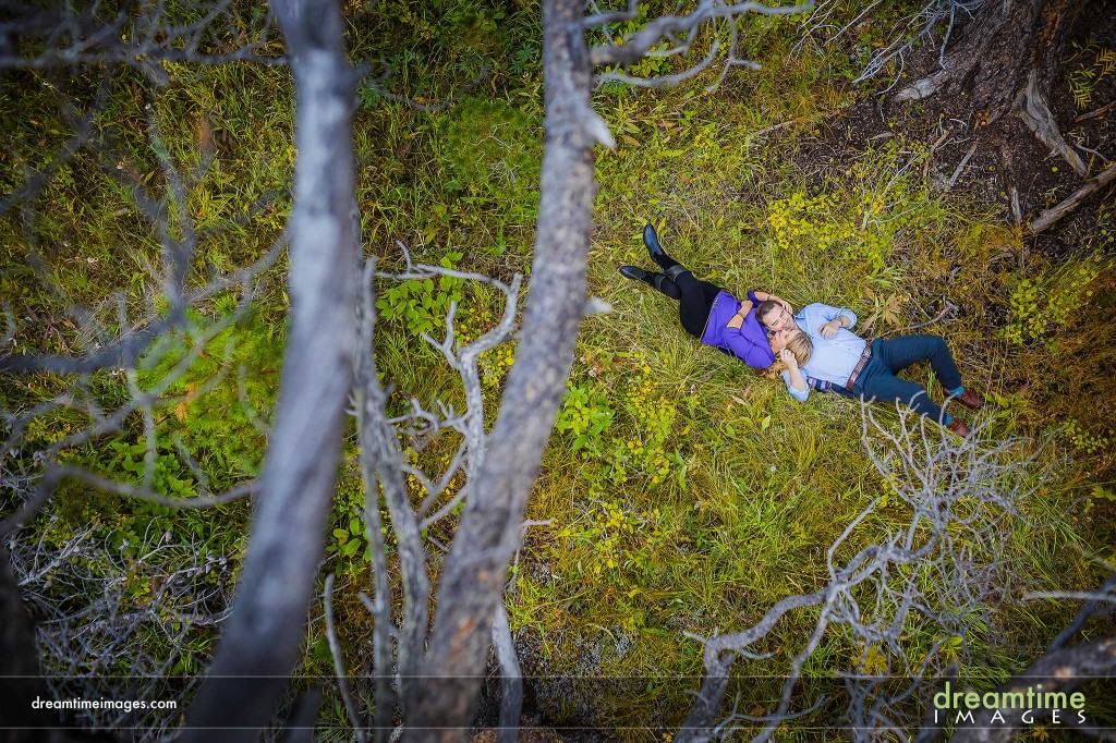 Engaged couple on forest floor