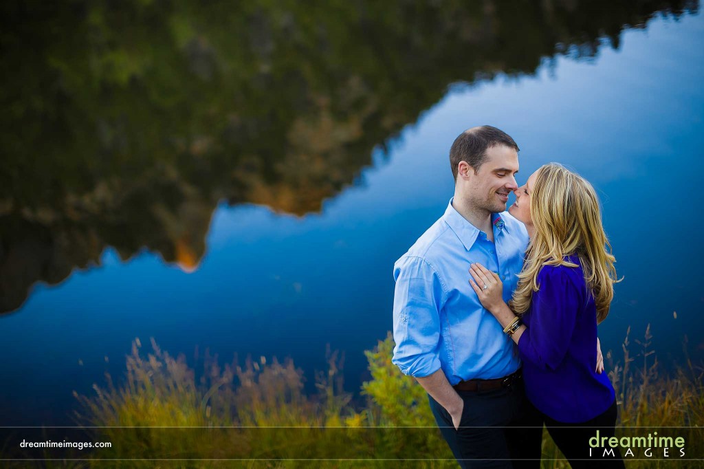 Engaged couple kissing by Lily Lake