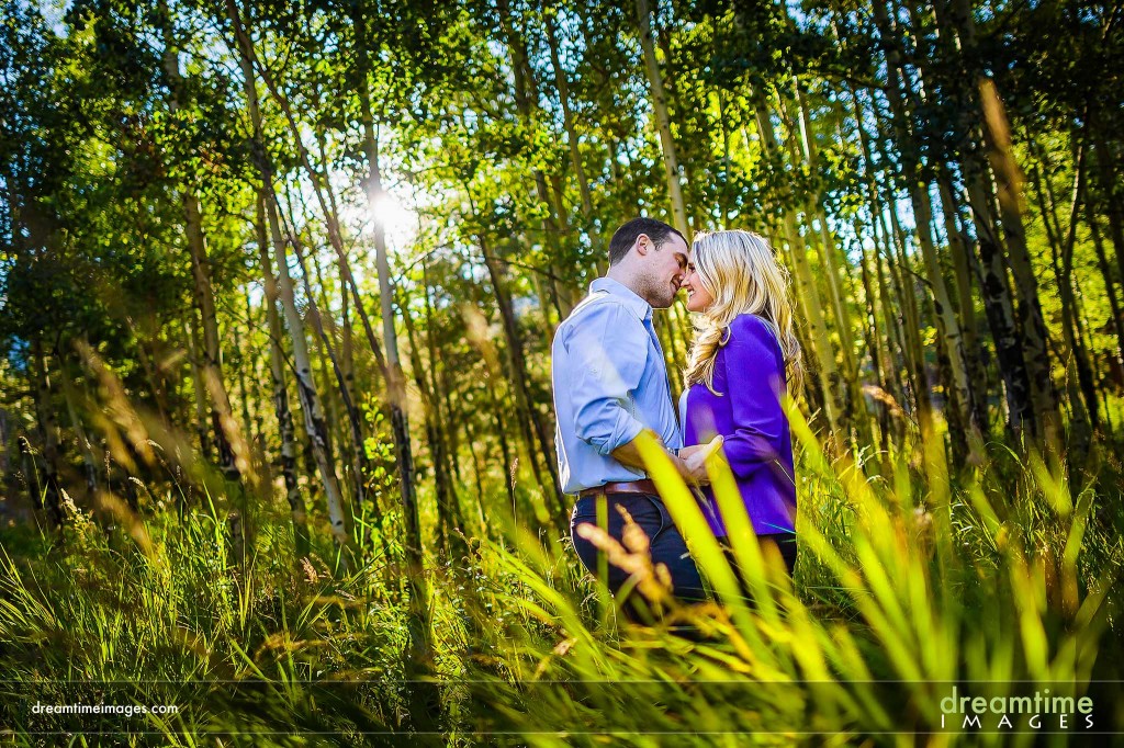 Couple kissing in aspen grove